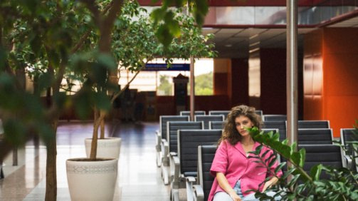 woman-sitting-bench-full-shot